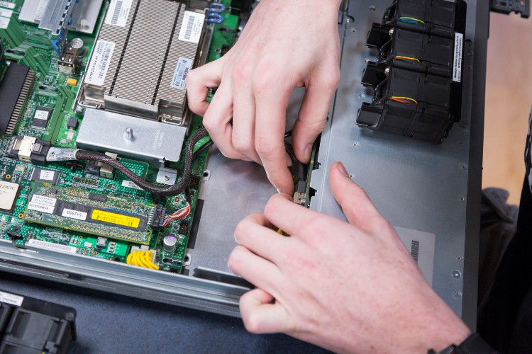 Close up of someone working on a circuit board.